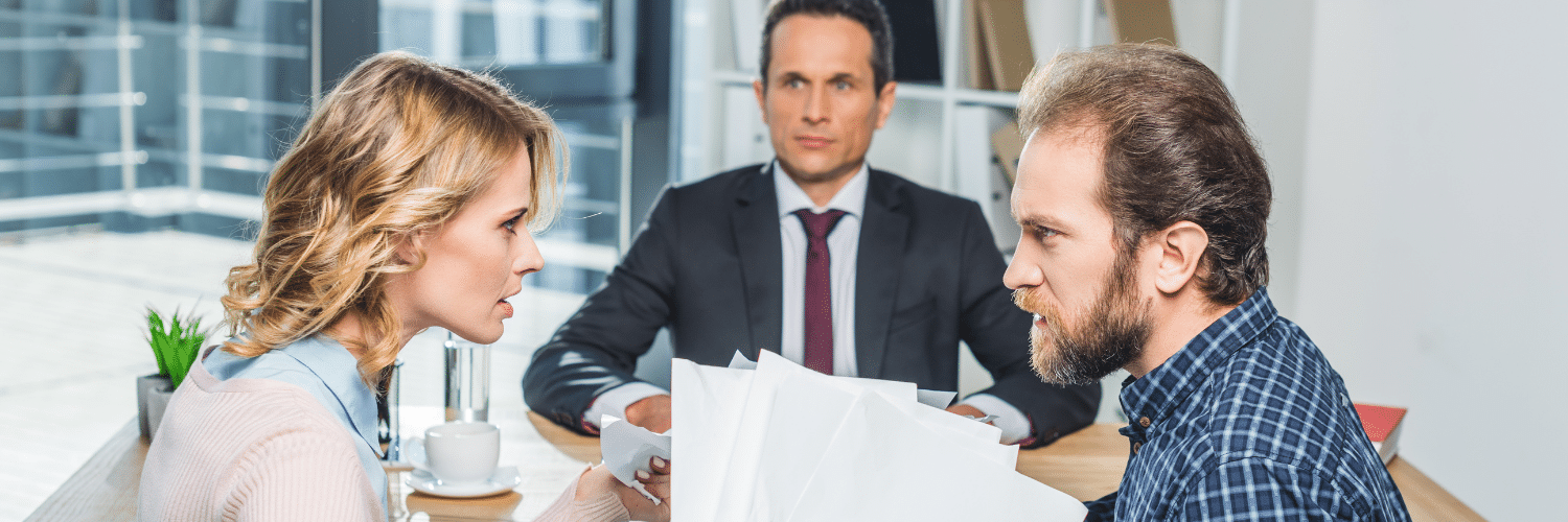 side view of couple having argument during meeting with lawyer in office