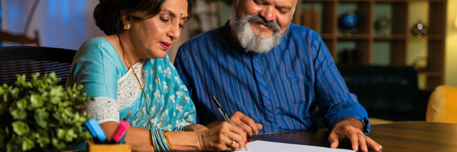 elderly couple signing legal documentation